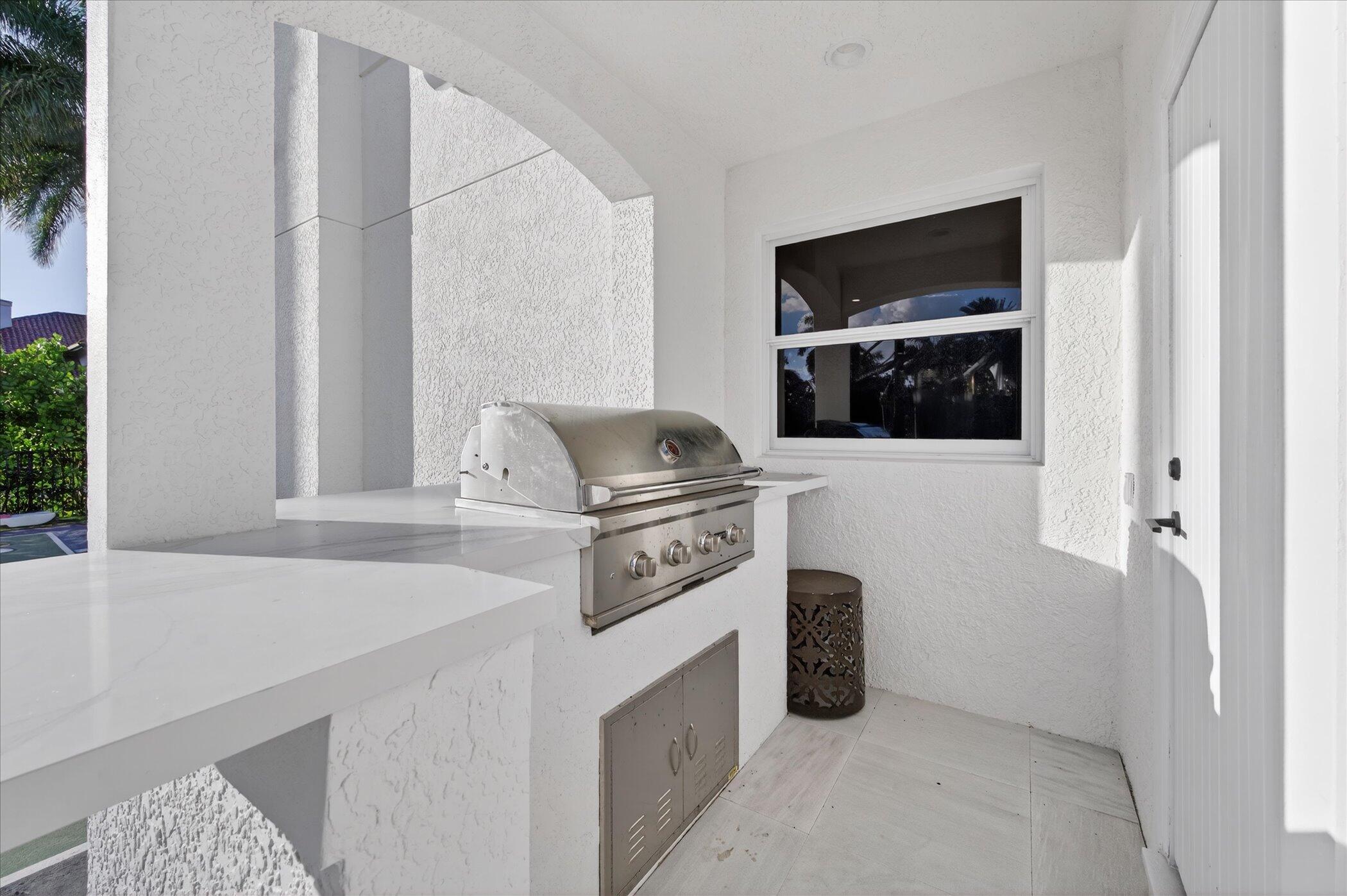 3872 Northwest 53rd Street Boca Raton, FL 33496 - Photo 41 of 43 a kitchen with a stove and a microwave