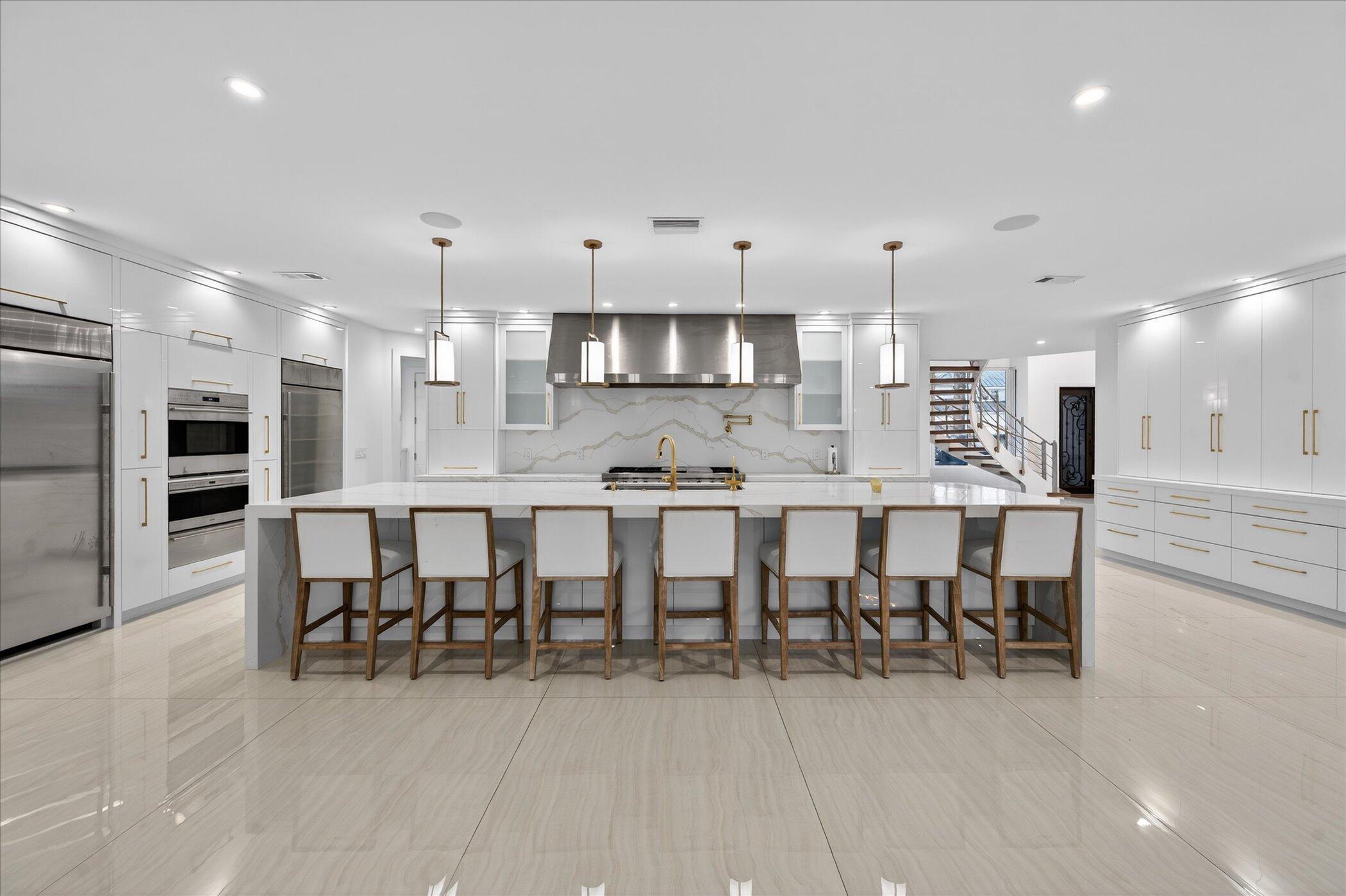 3872 Northwest 53rd Street Boca Raton, FL 33496 - Photo 9 of 43 a large kitchen with a table and chairs