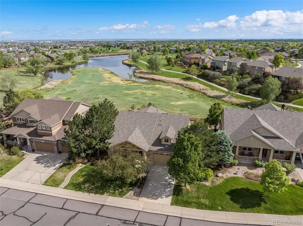 an aerial view of residential houses with outdoor space and river