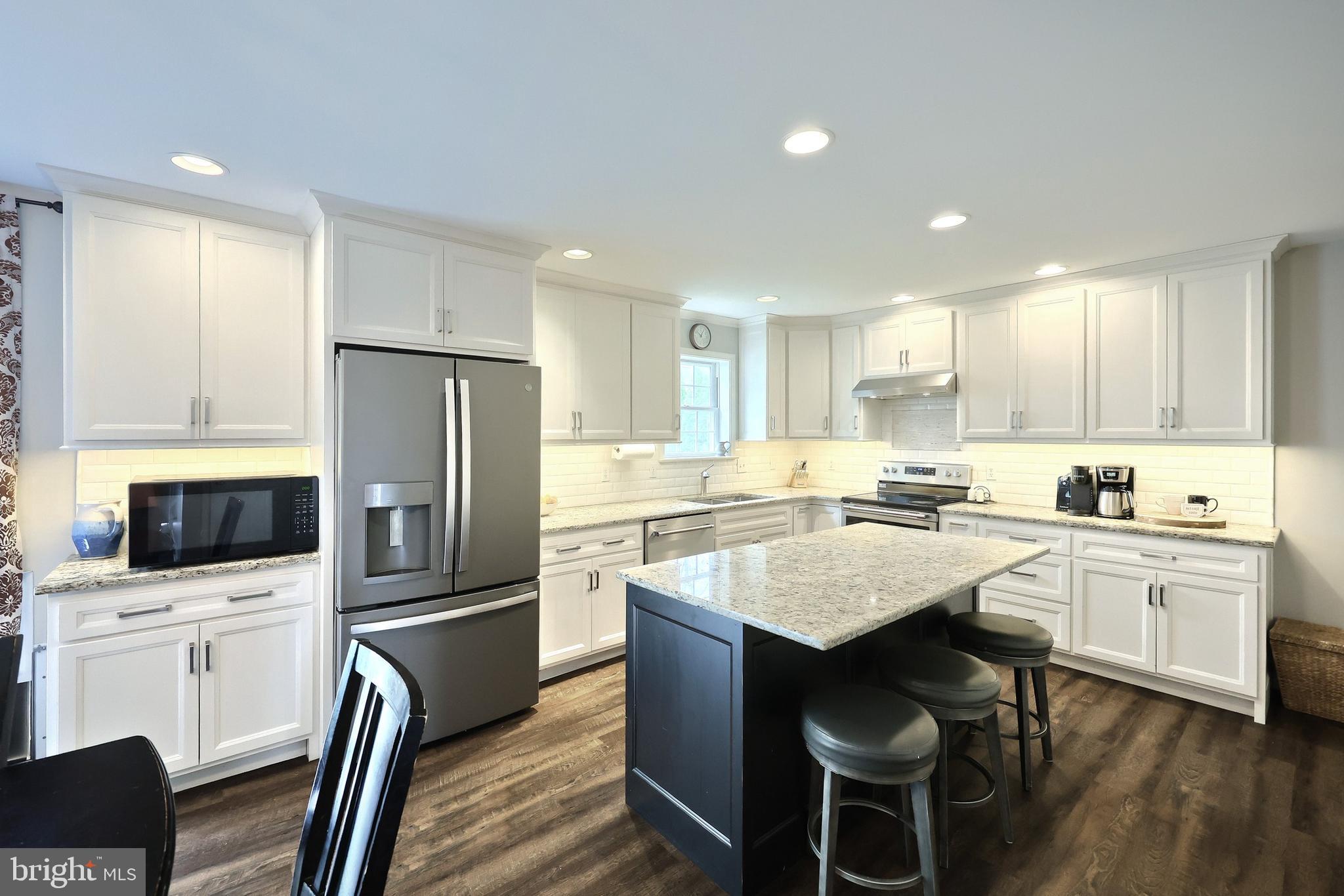710 Apple Tree Lane Mount Wolf, PA 17347 - Photo 14 of 47 a kitchen with white cabinets and stainless steel appliances