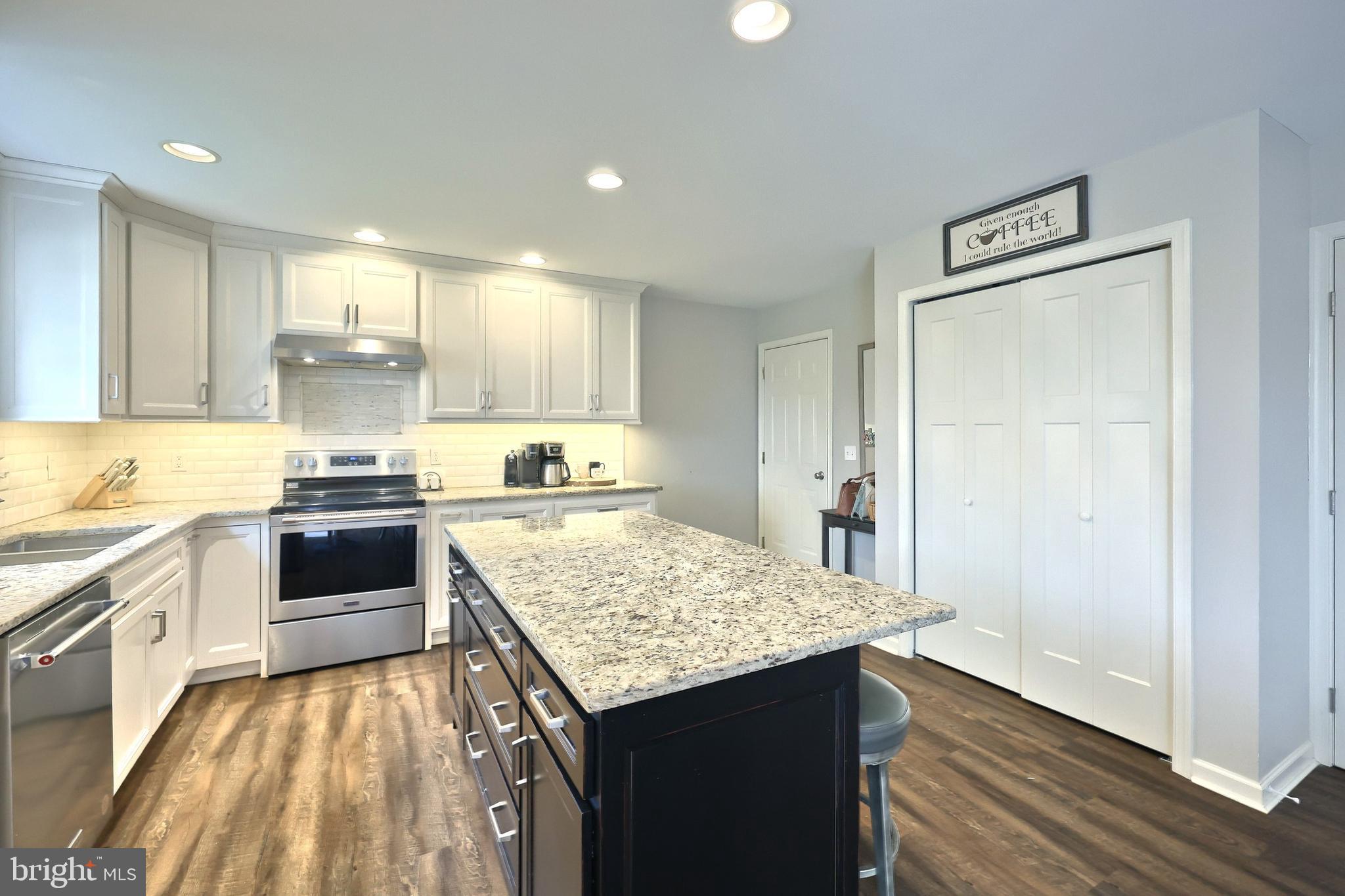 710 Apple Tree Lane Mount Wolf, PA 17347 - Photo 16 of 47 a kitchen with kitchen island a counter top space a sink stainless steel appliances and cabinets