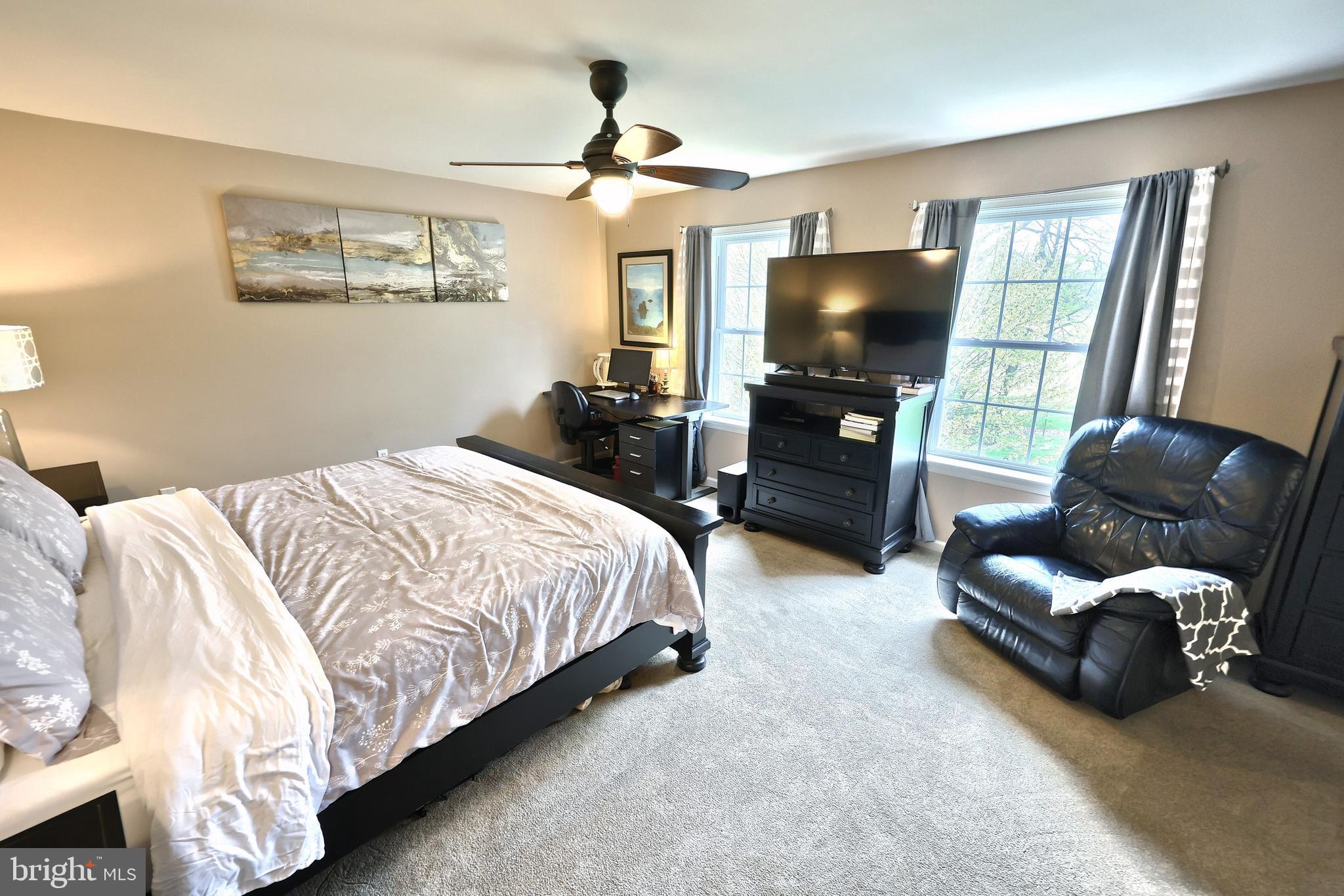 710 Apple Tree Lane Mount Wolf, PA 17347 - Photo 19 of 47 a spacious bedroom with a bed and a flat screen tv