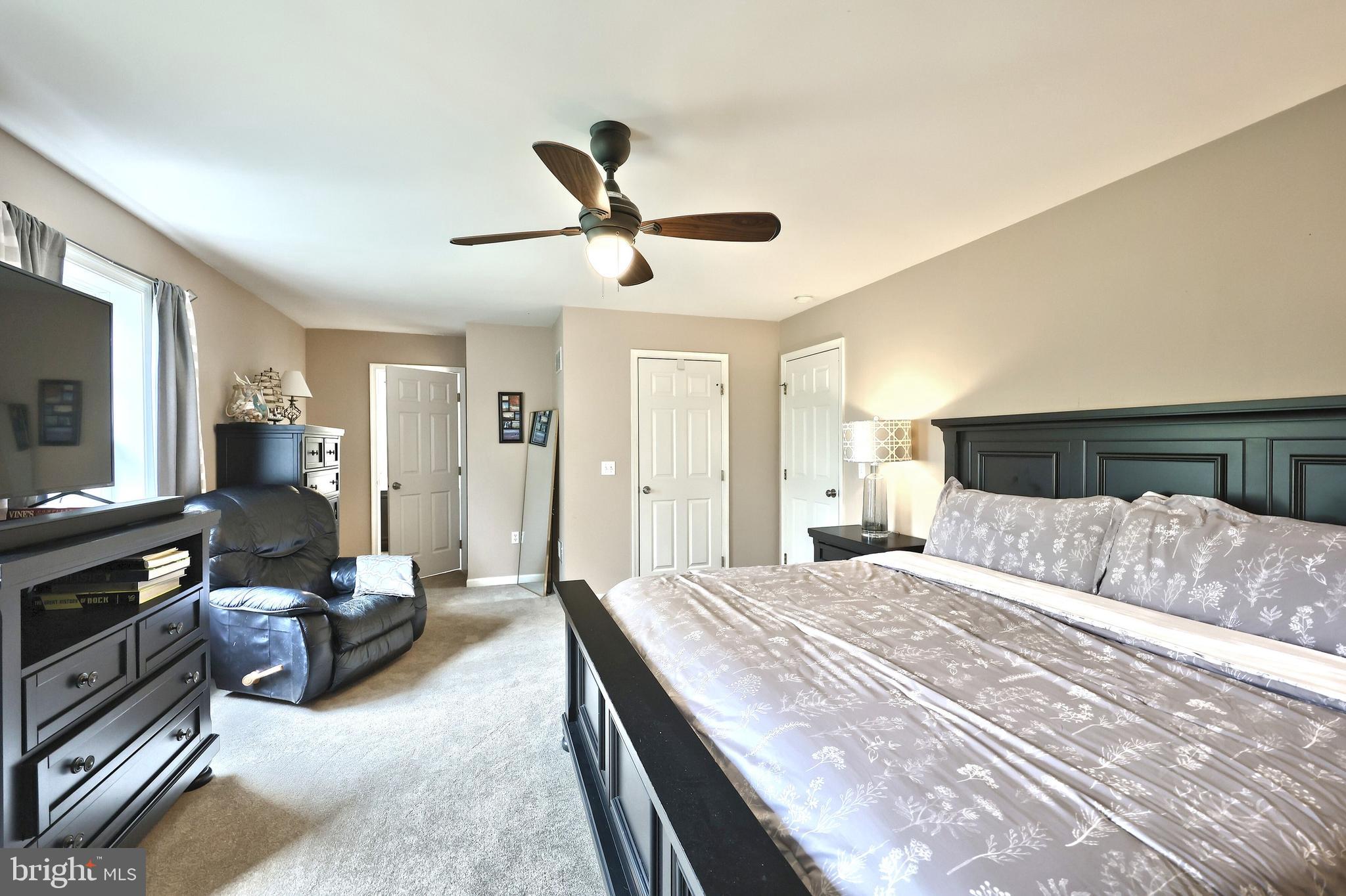 710 Apple Tree Lane Mount Wolf, PA 17347 - Photo 20 of 47 a spacious bedroom with a bed and a flat screen tv