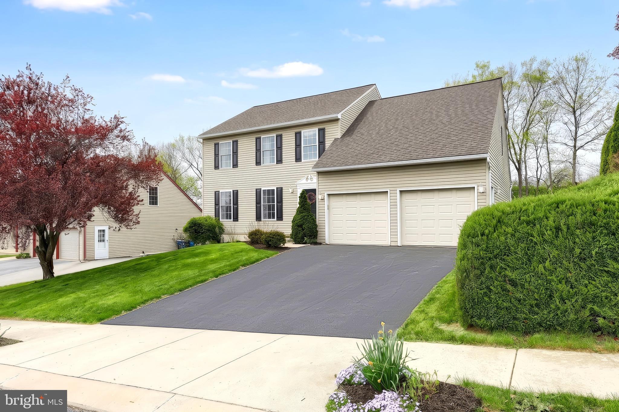 710 Apple Tree Lane Mount Wolf, PA 17347 - Photo 41 of 47 a front view of a house with a yard and garage