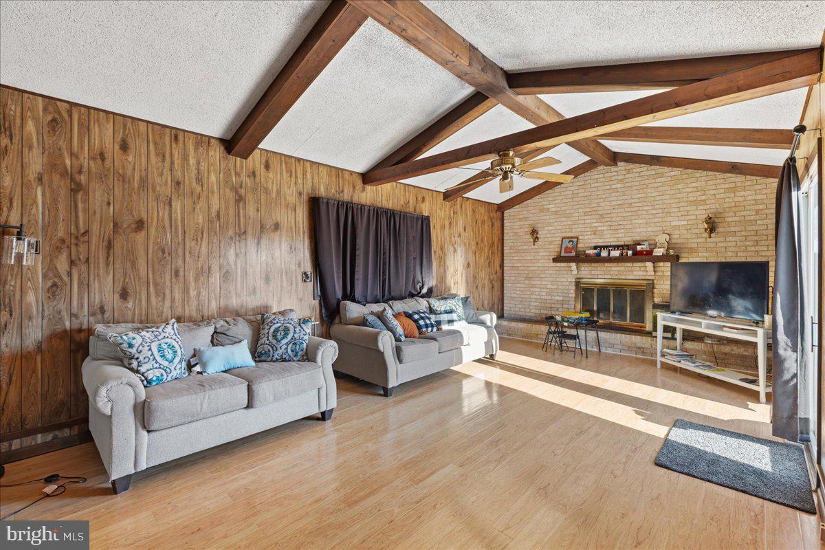 121 Catherine Avenue Buena, NJ 08310 - Photo 11 of 34 a living room with furniture and a fireplace