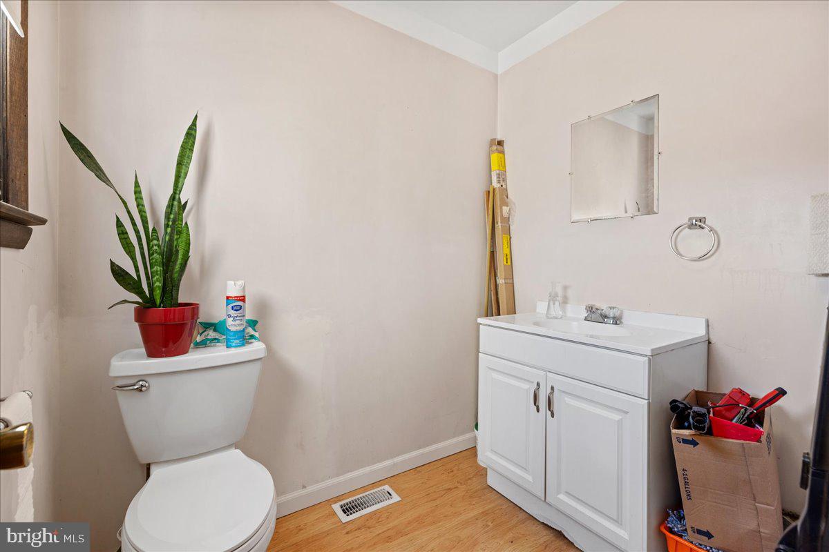 121 Catherine Avenue Buena, NJ 08310 - Photo 14 of 34 a bathroom with a toilet sink and mirror