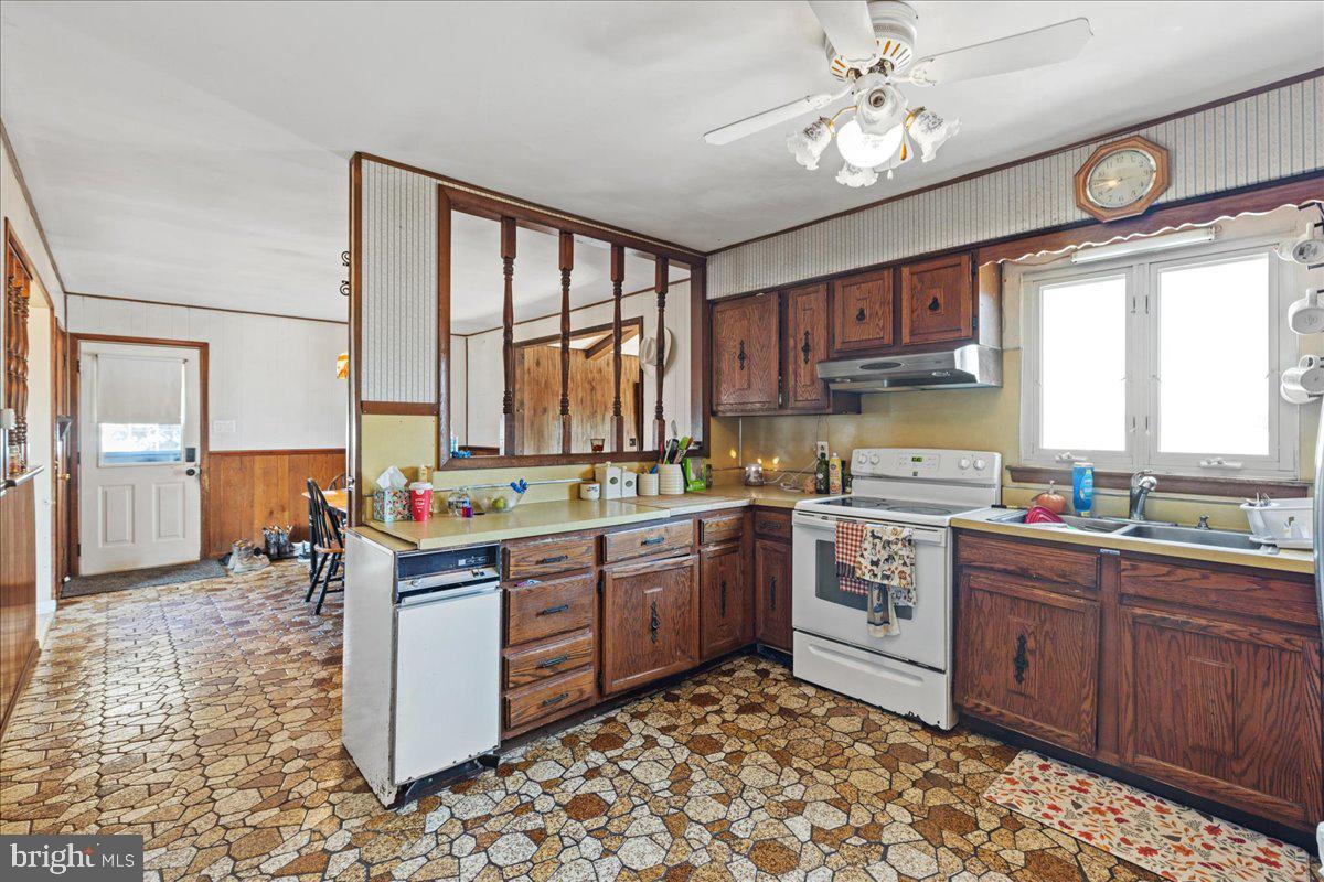 121 Catherine Avenue Buena, NJ 08310 - Photo 16 of 34 a kitchen with a sink stove and cabinets