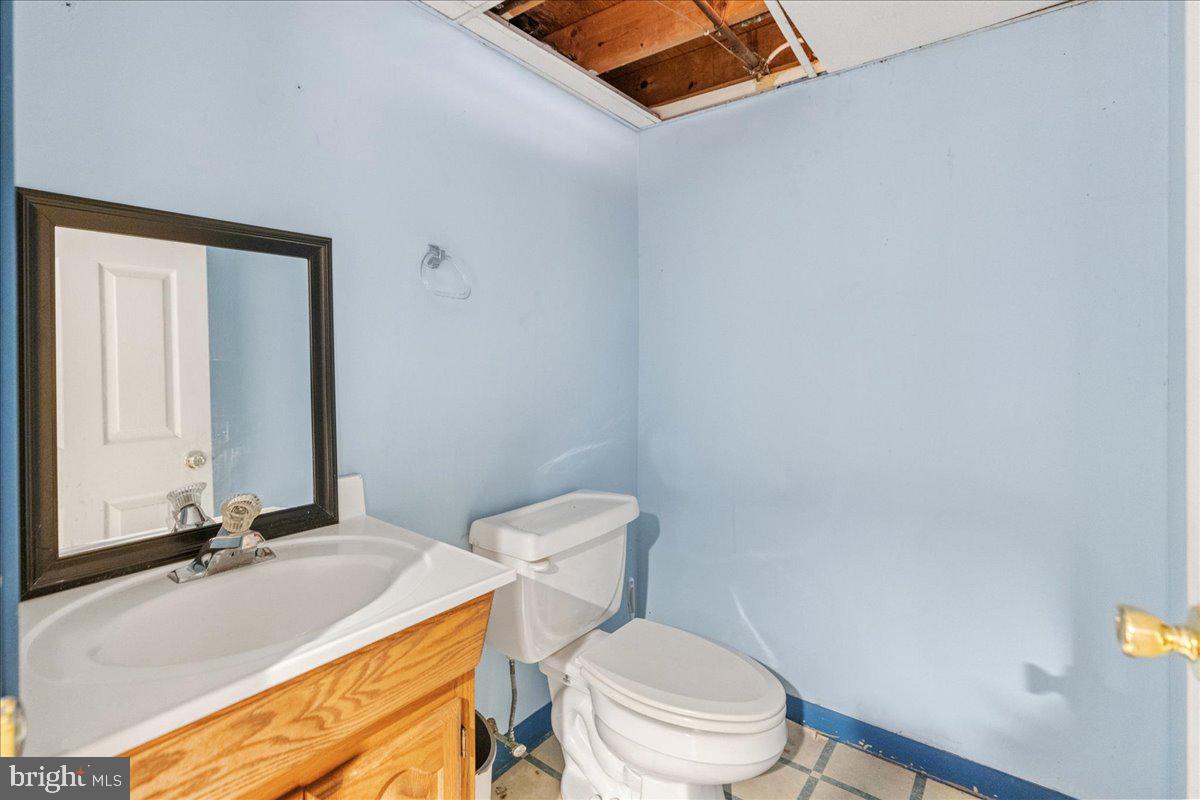 121 Catherine Avenue Buena, NJ 08310 - Photo 27 of 34 a bathroom with a granite countertop toilet and a sink
