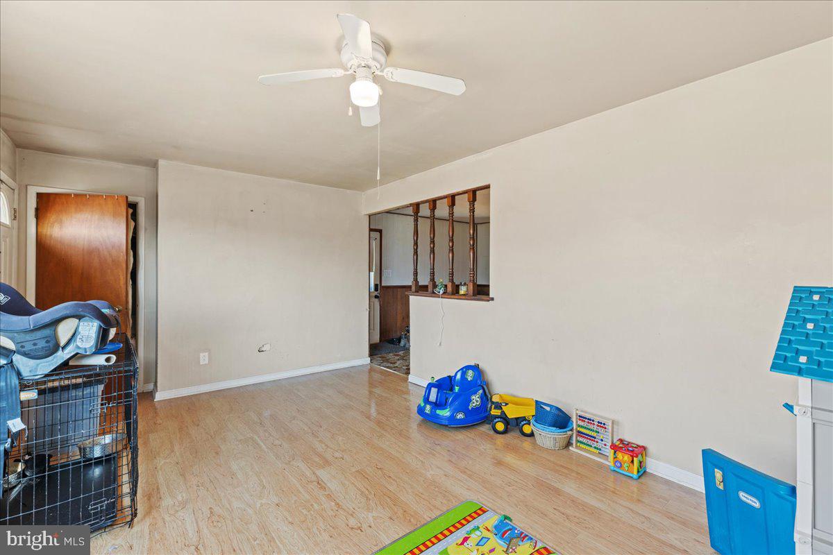 121 Catherine Avenue Buena, NJ 08310 - Photo 7 of 34 a view of an empty room with wooden floor and fan