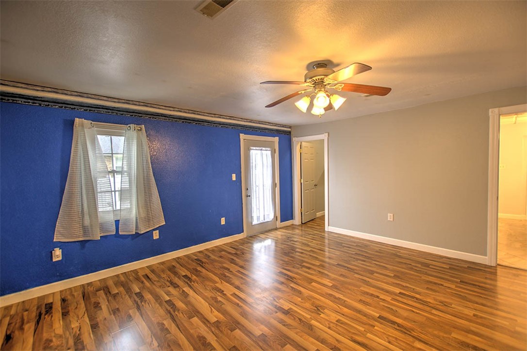 4402 East Rosewood Drive Decatur, IL 62521 - Photo 12 of 23 a view of empty room with window and wooden floor