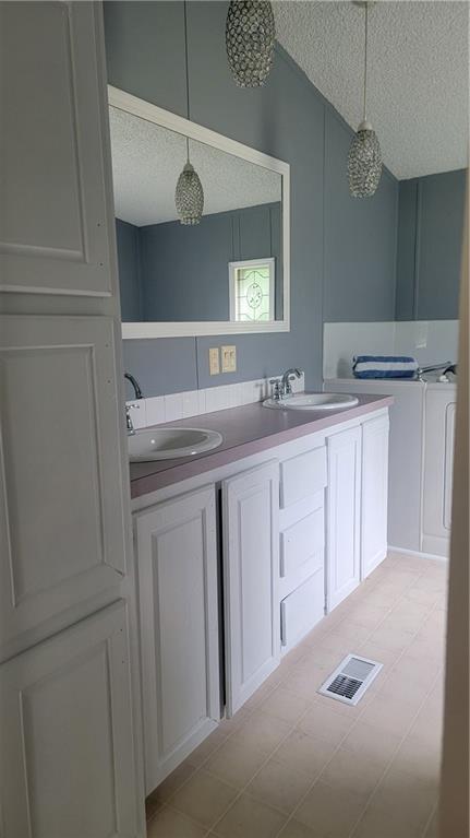 174 Luther Circle Villa Rica, GA 30180 - Photo 21 of 32 a kitchen with white cabinets and sink