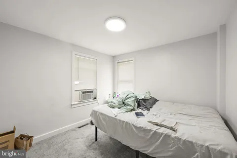 a bed room with a bed and a chair