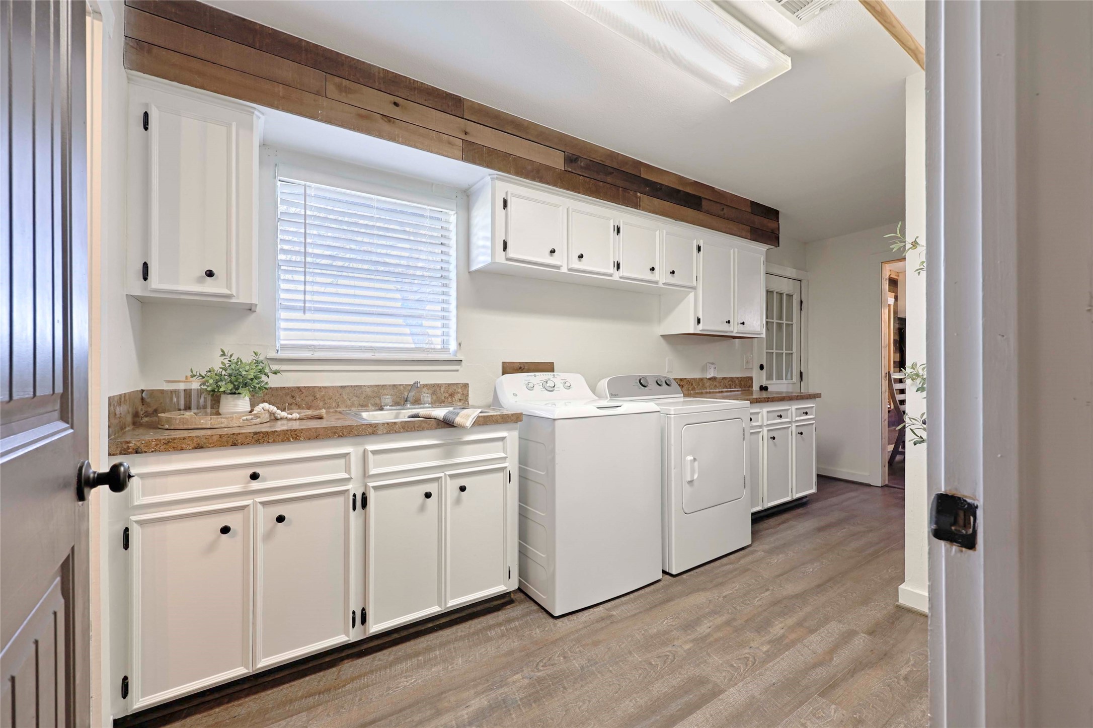1055 County Road Weimar, TX 78962 - Photo 20 of 35 Inviting laundry room with abundant storage, counters for folding, and timeless country style.