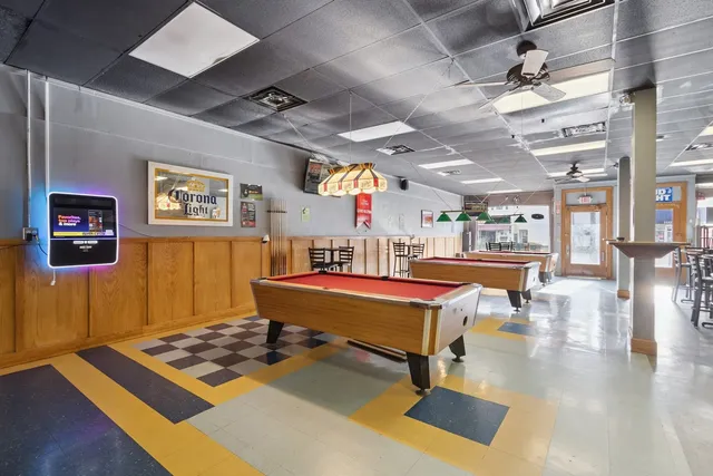 a kitchen with stainless steel appliances granite countertop a sink a stove and a refrigerator