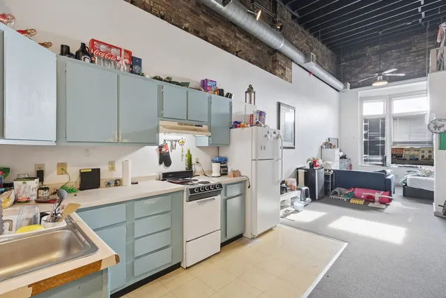a living room with furniture a couch and a large window