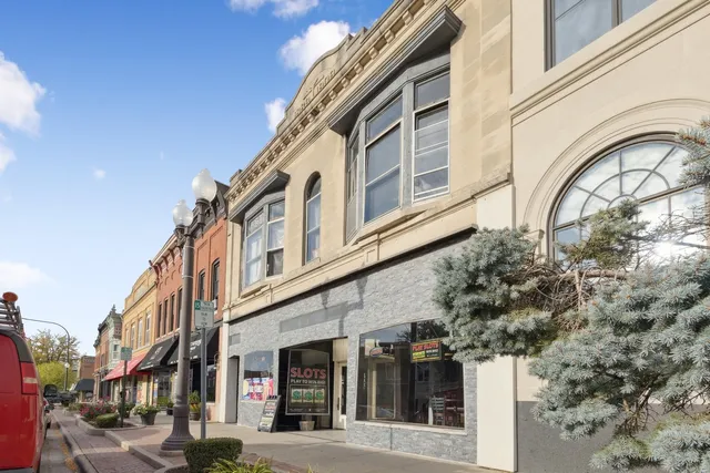 a front view of a building with a garden