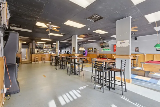 a dining room with furniture and wooden floor