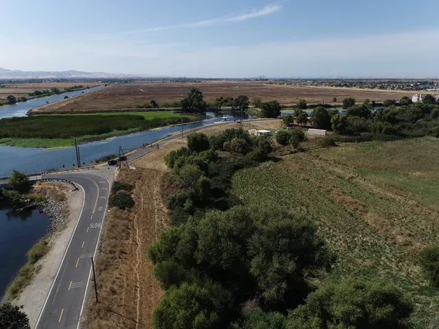 an aerial view of a residential houses with outdoor space