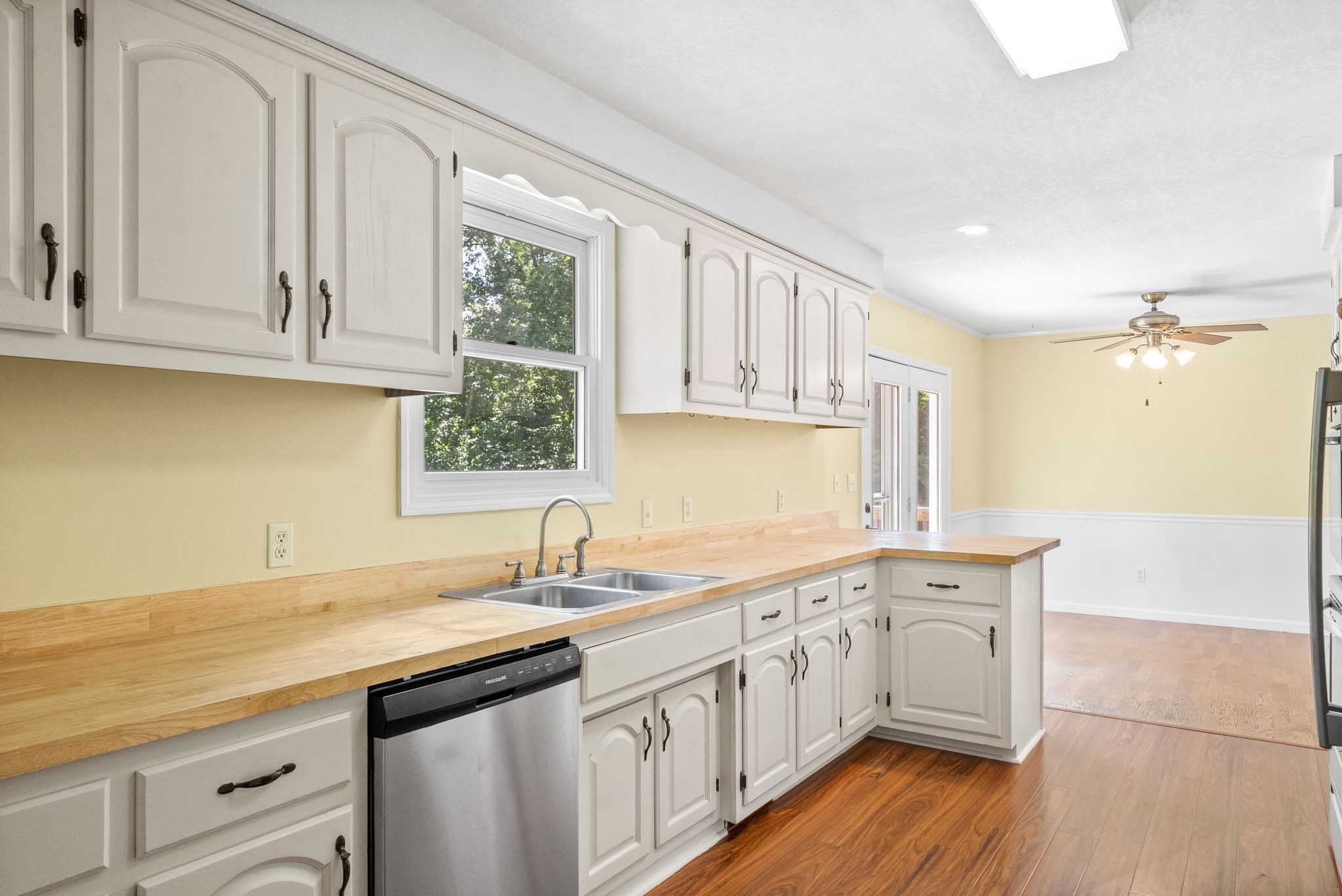 472 Wooten Road Clarksville, TN 37042 - Photo 15 of 39 The kitchen upgrades include white painted cabinets, new butcher block countertops, newer stainless appliances, a new stove and new flooring!