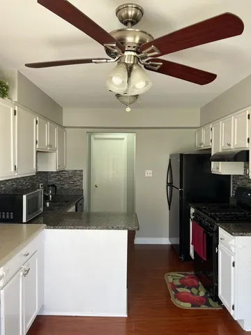 a kitchen with stainless steel appliances a stove a refrigerator and cabinets