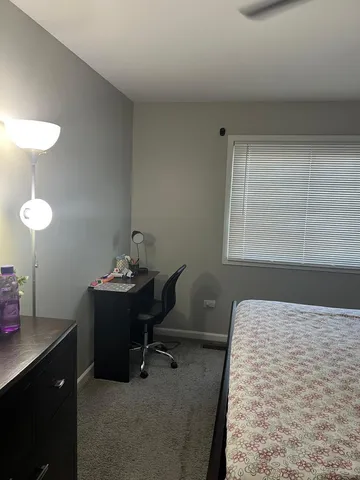 a bedroom with a bed and a desk