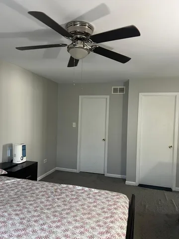 a view of a livingroom with a ceiling fan and wooden floor