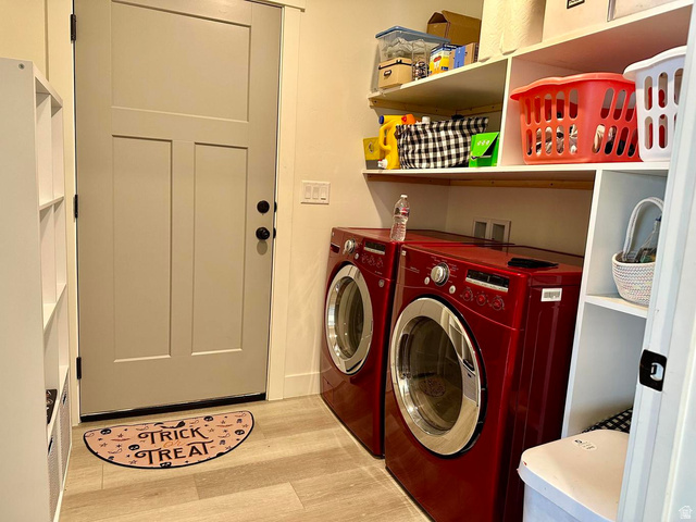 4349 Half Mile Road East Enoch, UT 84721 - Photo 22 of 36 Laundry area with washing machine and clothes dryer and light wood-style floors