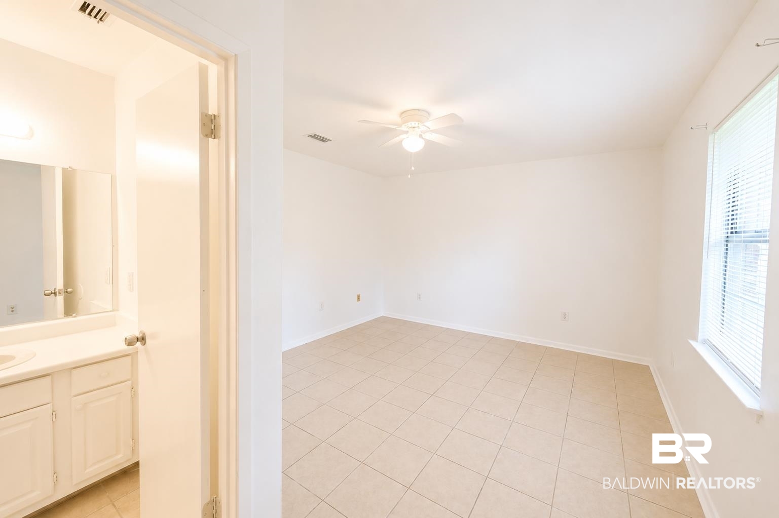 614 East Gate Circle Foley, AL 36535 - Photo 23 of 31 Spacious room featuring neutral tile flooring, a ceiling fan, and a window with blinds