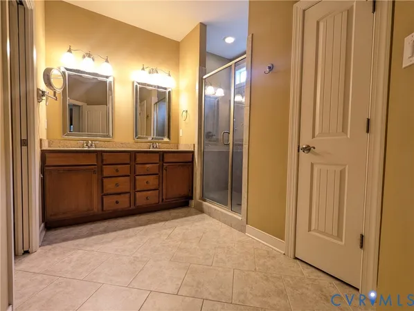 a spacious bathroom with a mirror a shower and a sink