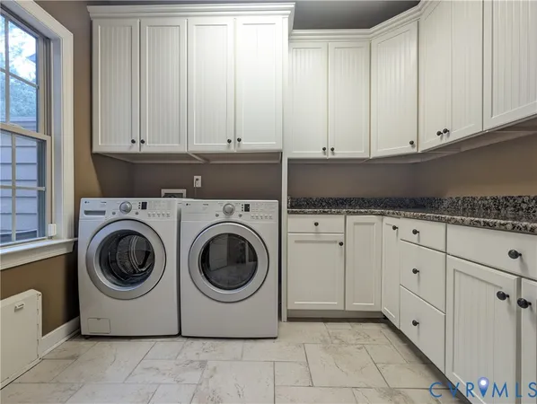 a utility room with sink dryer and washer