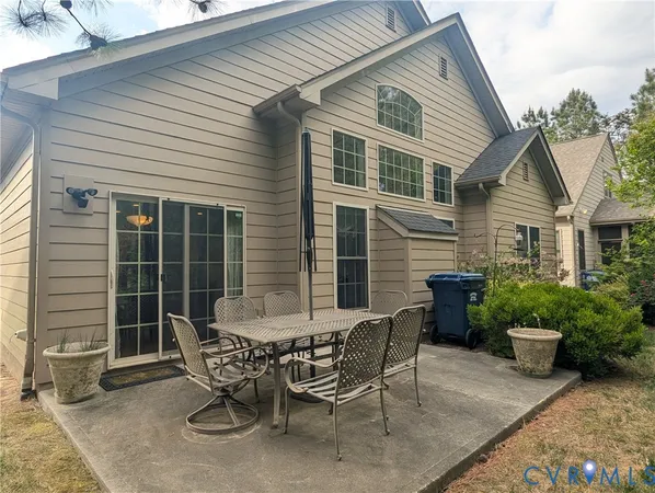 a view of a house with patio and a yard