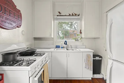 a kitchen with a stove a sink and a refrigerator