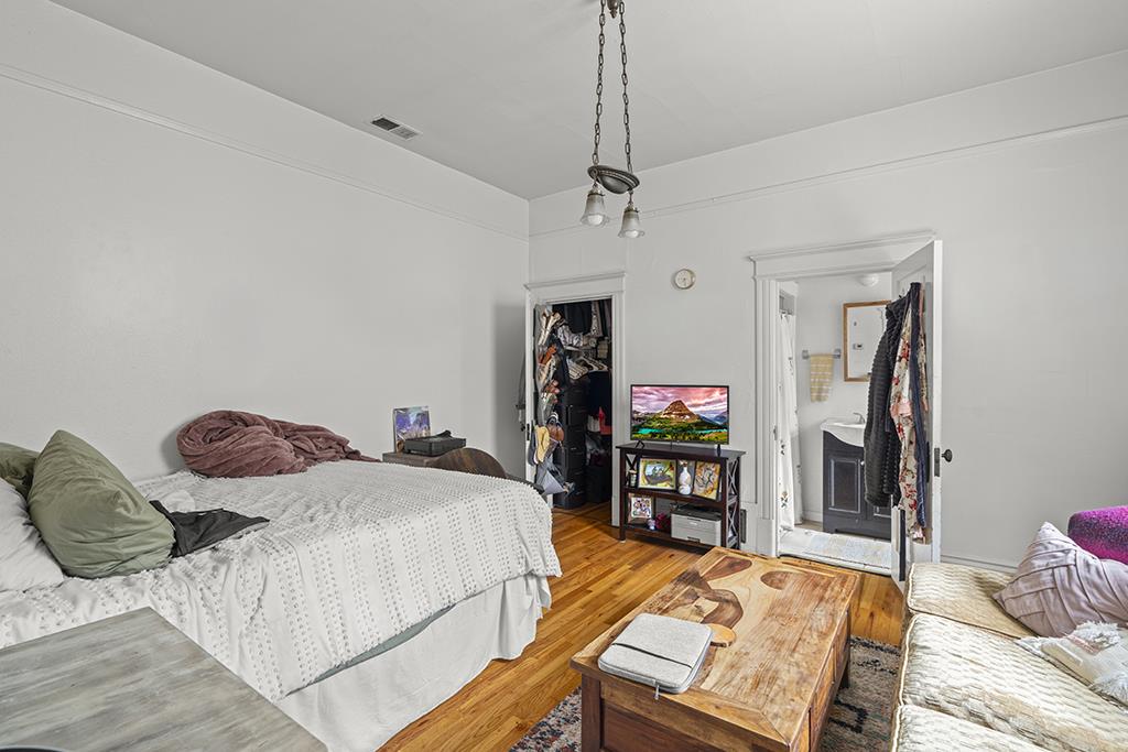 90 South 13th Street San Jose, CA 95112 - Photo 8 of 16 a bedroom with bed and wooden floor