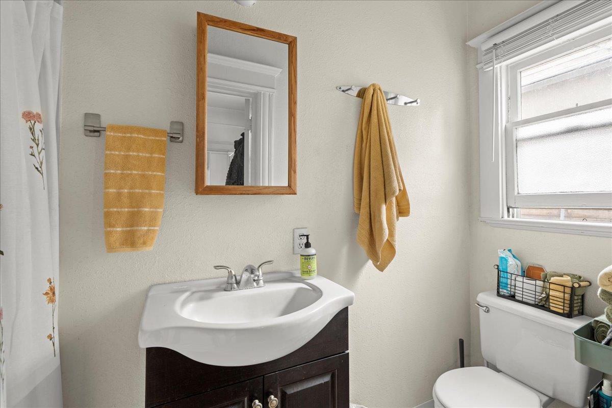 90 South 13th Street San Jose, CA 95112 - Photo 9 of 16 a bathroom with a toilet sink and mirror