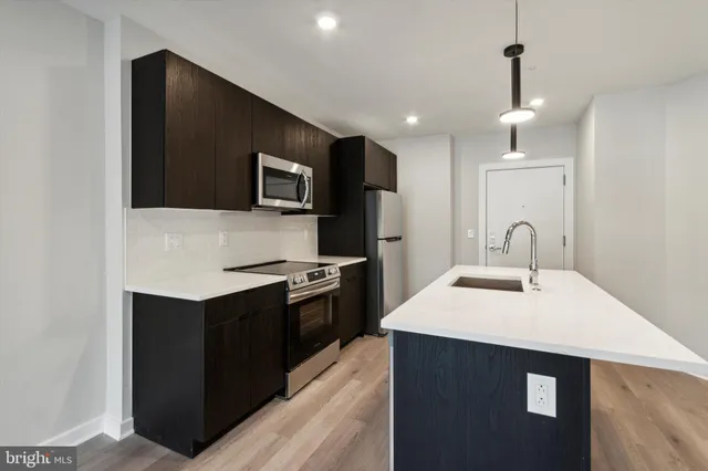 a kitchen with stainless steel appliances granite countertop a sink and a stove