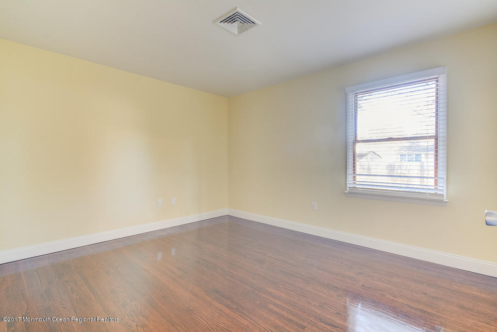 156 Wave Road Manahawkin, NJ 08050 - Photo 12 of 18 wooden floor in an empty room with a window