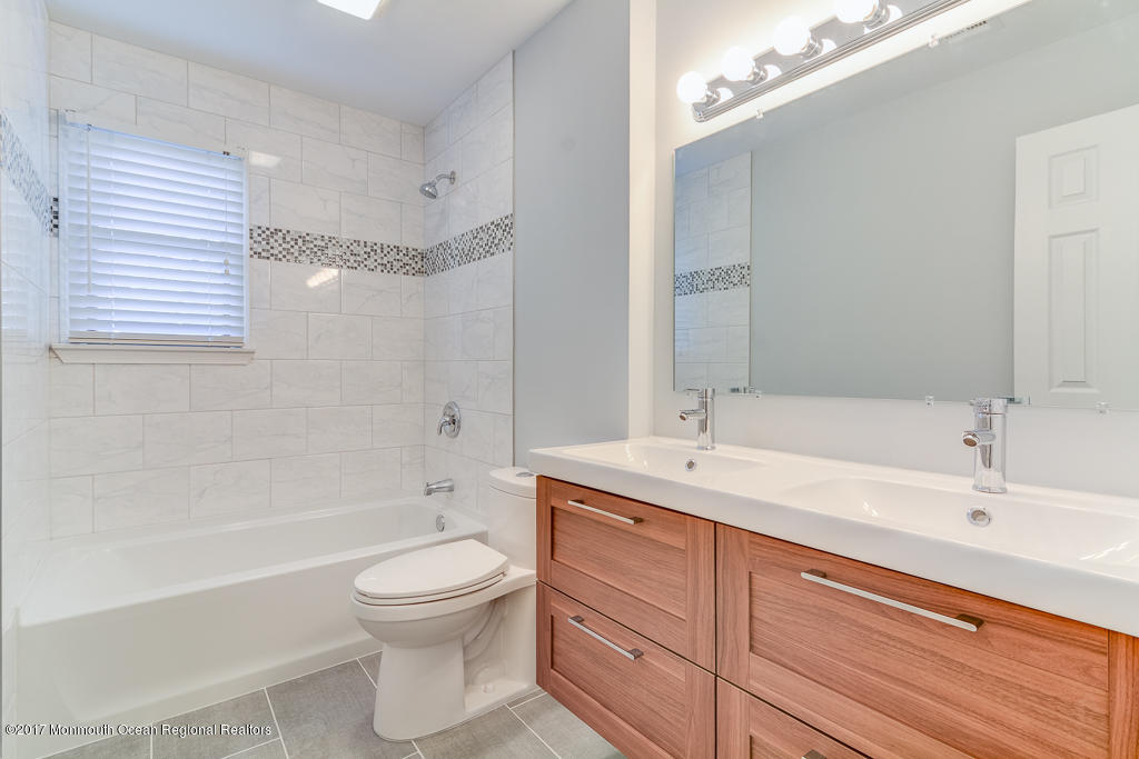 156 Wave Road Manahawkin, NJ 08050 - Photo 13 of 18 a bathroom with a granite countertop sink a toilet and shower