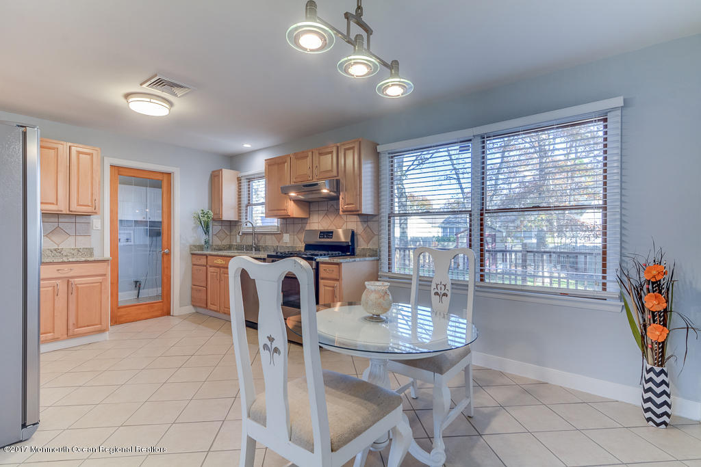 156 Wave Road Manahawkin, NJ 08050 - Photo 5 of 18 a kitchen with granite countertop a sink and a refrigerator