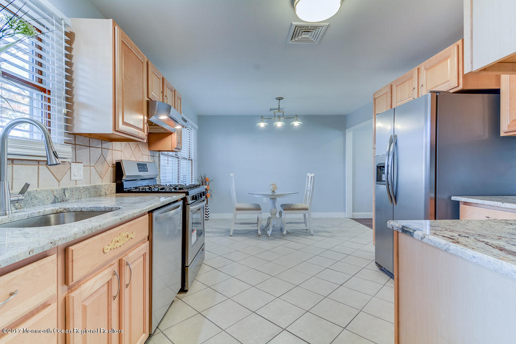 156 Wave Road Manahawkin, NJ 08050 - Photo 6 of 18 a kitchen with kitchen island granite countertop a sink cabinets and stainless steel appliances