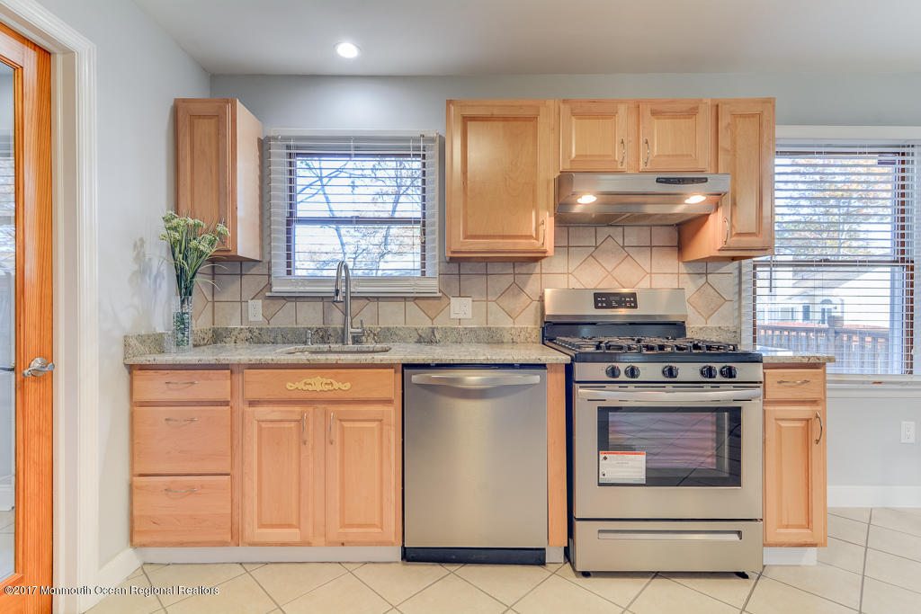 156 Wave Road Manahawkin, NJ 08050 - Photo 7 of 18 a kitchen with stainless steel appliances granite countertop a stove a sink and a microwave