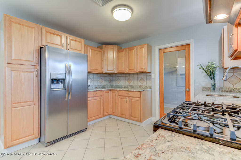 156 Wave Road Manahawkin, NJ 08050 - Photo 8 of 18 a kitchen with stainless steel appliances granite countertop a refrigerator and a sink