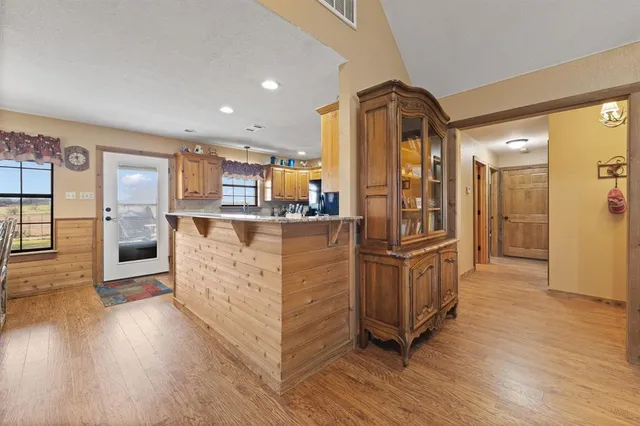 a kitchen with stainless steel appliances granite countertop a refrigerator and a stove top oven
