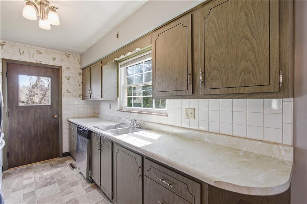 64 Harmon Creek Road Burgettstown, PA 15021 - Photo 10 of 29 a kitchen with a sink a cabinets and window