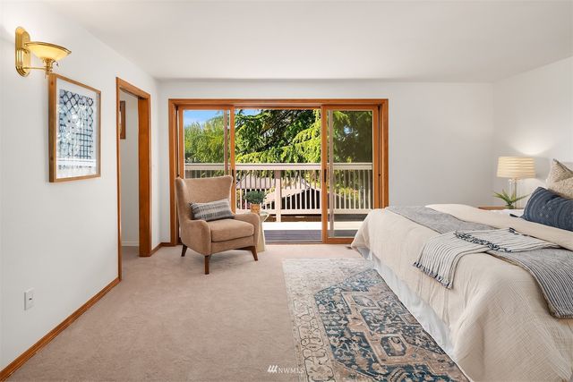 a bed sitting in a bedroom next to a window