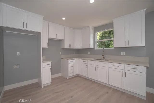 a kitchen with granite countertop a sink and cabinets