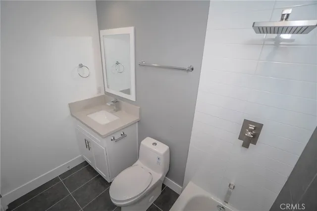 a white toilet sitting next to a bathroom sink