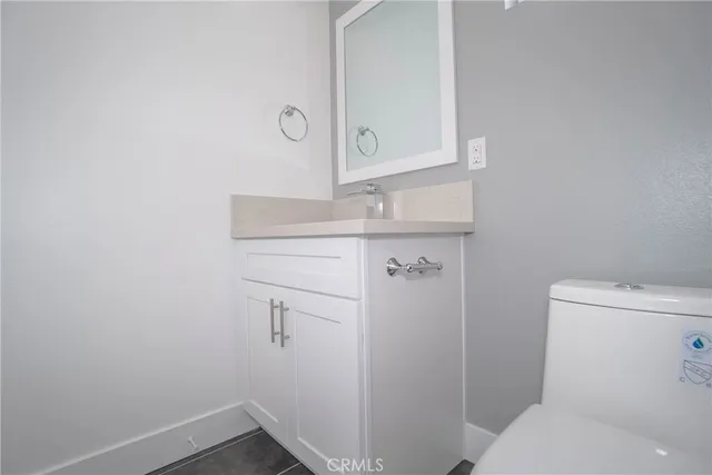 a bathroom with a toilet sink and vanity