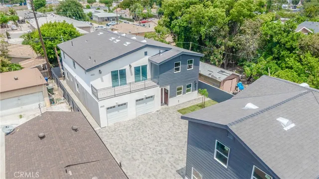 an aerial view of a house with a yard