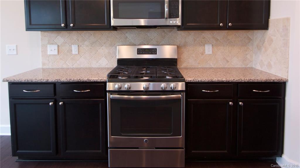 5706 Joshua Cain Road, Unit L0041 Charlotte, NC 28213 - Photo 2 of 23 a stove top oven sitting inside of a kitchen