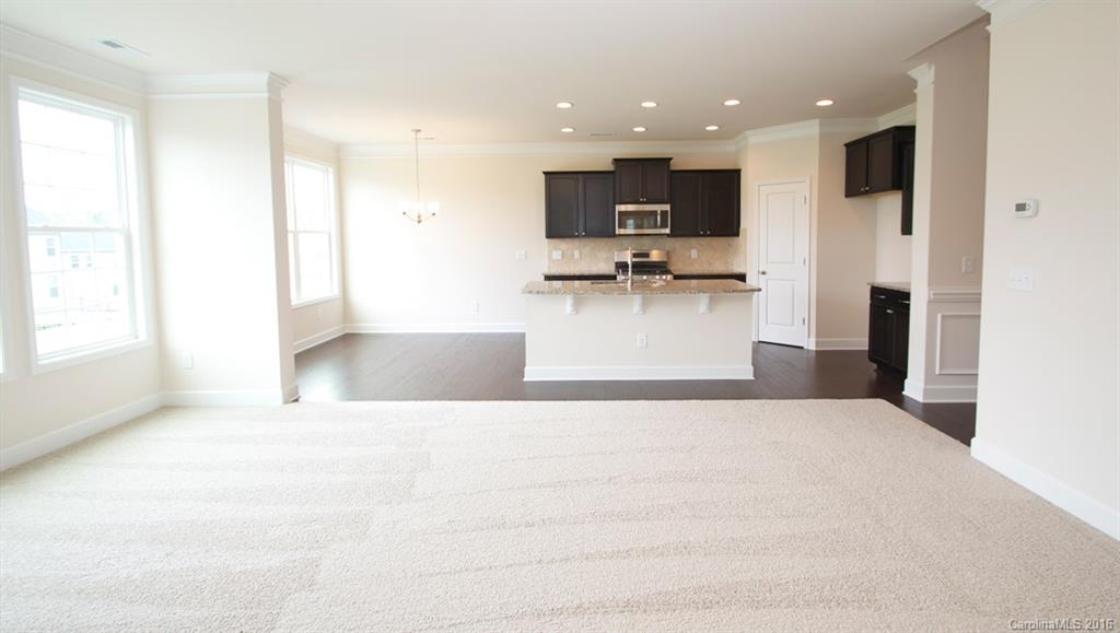 5706 Joshua Cain Road, Unit L0041 Charlotte, NC 28213 - Photo 19 of 23 a view of kitchen with stainless steel appliances kitchen island sink refrigerator and microwave